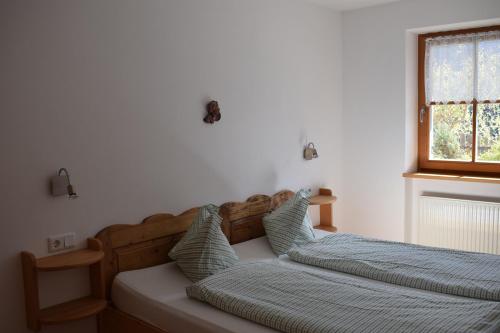 een slaapkamer met 2 bedden en een raam bij Kellnerhof in Nova Levante