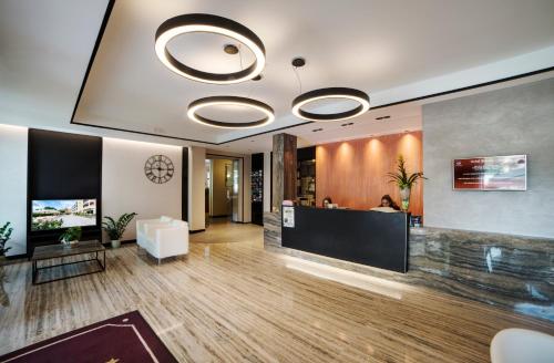 a lobby with a reception desk in a building at Hotel Bisesti ***S in Garda