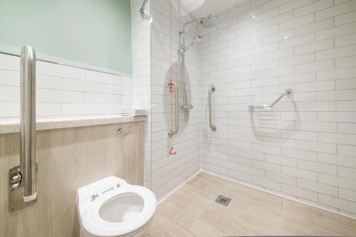 a bathroom with a toilet and a shower at The Beach Arms by Innkeeper's Collection in Oakley