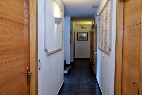 a corridor of a hallway with a long hallway at Elcano in Málaga