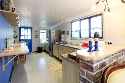 a kitchen with a stone counter top in a room at Lentelus Guesthouse in George