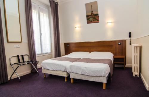 Ένα ή περισσότερα κρεβάτια σε δωμάτιο στο Hotel Paris Bruxelles