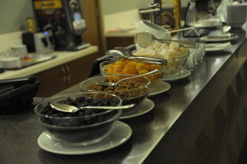a buffet line with bowls of different types of food at Nearport Hotel Sabiha Gokcen Airport in Istanbul