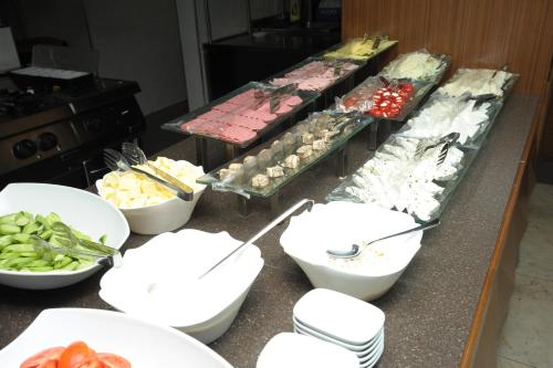 a kitchen counter with bowls and plates of food at Nearport Hotel Sabiha Gokcen Airport in Istanbul