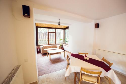 a living room with a table and a couch at Pensiunea Comarnic-Moisa in Comarnic