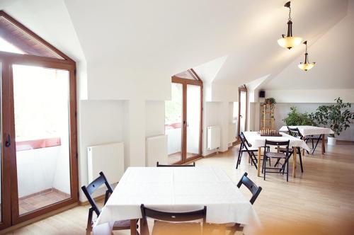 a group of tables and chairs in a room at Pensiunea Comarnic-Moisa in Comarnic