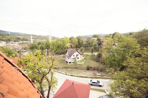 an aerial view of a house and a car on a road at Pensiunea Comarnic-Moisa in Comarnic