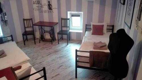 a room with a bed and a table and chairs at AB Hostel in Warsaw
