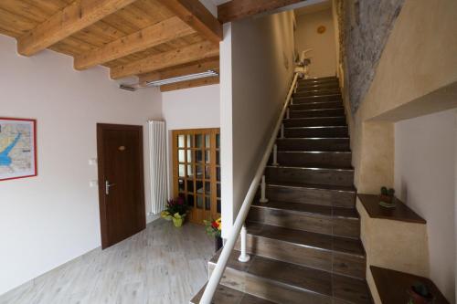 a staircase in a room with wooden floors and wooden ceilings at I Colli del Garda in Lonato del Garda