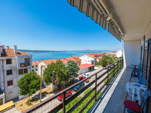 a balcony with a view of the water and buildings at Apartments Ankica in Crikvenica