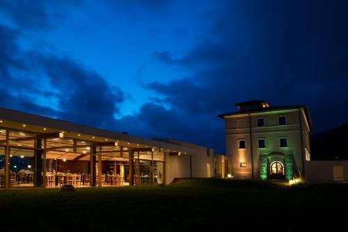 a building with a tower in front of it at night at Cincinnato Wine Resort in Cori