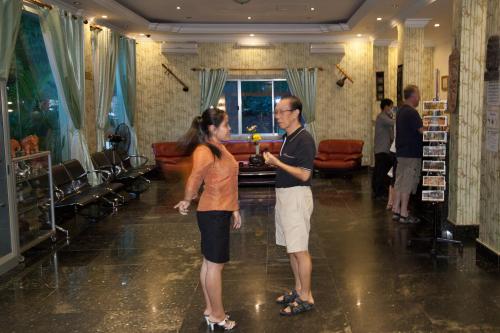 a man and a woman standing in a room at Parklane Hotel in Siem Reap
