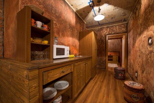 a kitchen with a counter with a microwave on it at Wellness Penzión Vila Mery in Poprad