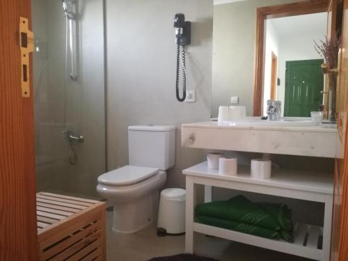 a bathroom with a toilet and a sink and a shower at Villa Cristina in Puerto del Carmen