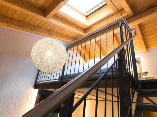 a chandelier hanging from a staircase in a house at Elements Hotel Christlessee in Oberstdorf