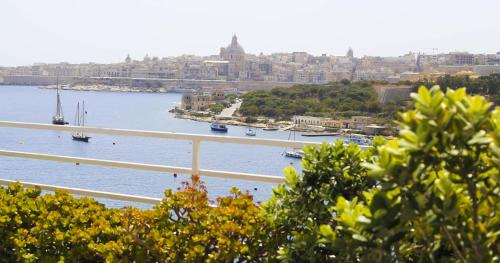a view of a harbor with boats in the water at Pebbles Boutique Aparthotel in Sliema
