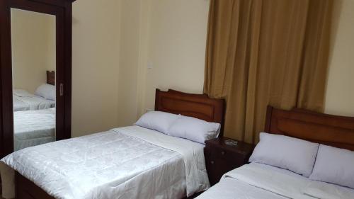 Postel nebo postele na pokoji v ubytování Royal Pyramids Inn