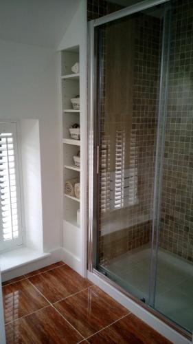 a bathroom with a shower and a glass shower stall at SunnySide-Cottage in Ennistymon