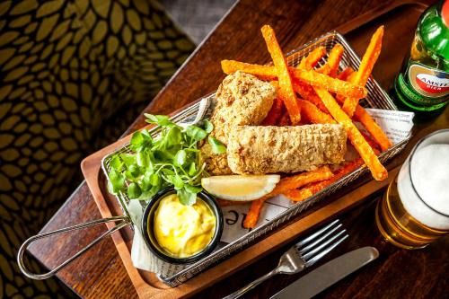a tray of food with a sandwich and french fries at Best Western Plus Pinewood Manchester Airport-Wilmslow Hotel in Handforth