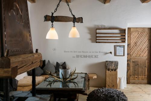 a room with two lights hanging from the wall at Hotel & Gourmetwirtshaus Kirchenwirt seit 1326 in Leogang