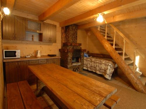a kitchen with a wooden table in a cabin at Готель Добрій in Vorokhta