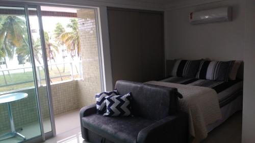 a living room with a couch and a window at Apartamento mobiliado intermares in Cabedelo