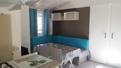 a small dining room with a table and chairs at Camping Dolce Vita in Calvi