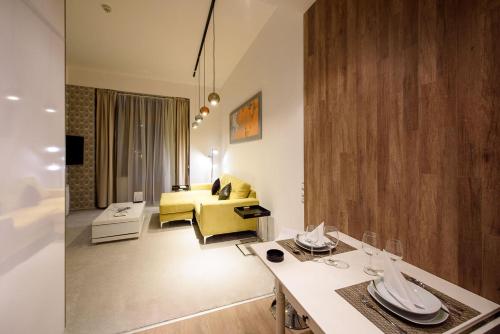 a living room with a yellow couch and a table at Karoly Corner Residences in Budapest