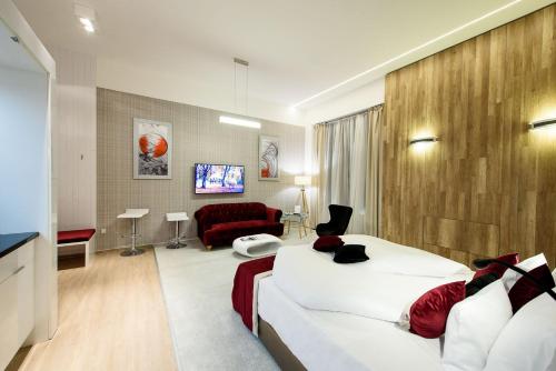 a hotel room with a bed and a couch at Karoly Corner Residences in Budapest