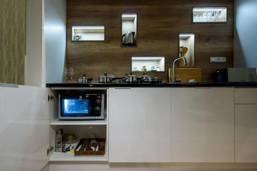 a kitchen with a sink and a microwave at Karoly Corner Residences in Budapest