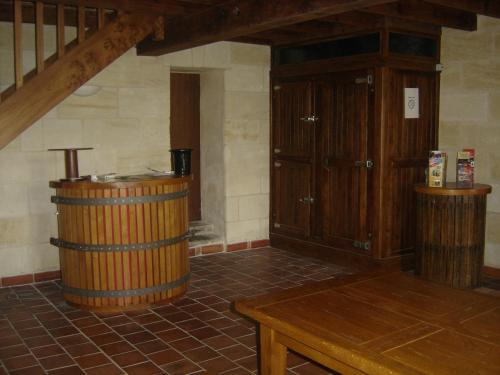 a room with a wooden barrel and a table at Chateau Laborde Marjolaine in Saint-Médard-de-Guizières