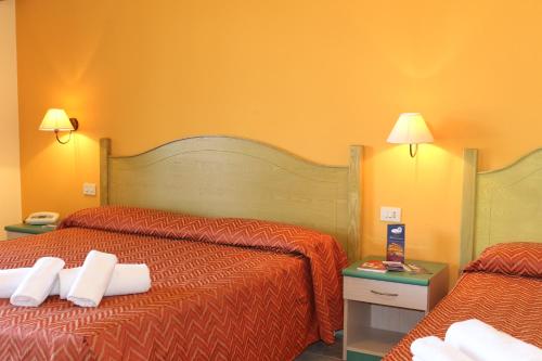 Postel nebo postele na pokoji v ubytování Hotel Rosa dei Venti