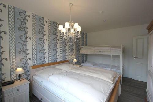 ヘルヌムにあるStrandeuleのベッドルーム(大きな白いベッド1台、シャンデリア付)