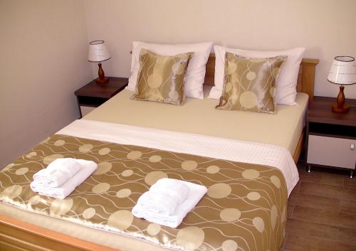 a bedroom with a large bed with two pillows at Apartments Skadarlija in Belgrade