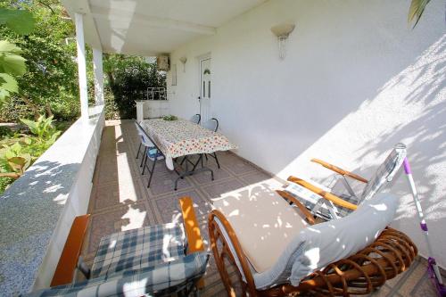 a patio with a table and chairs on a house at Apartments Nicol in Bibinje