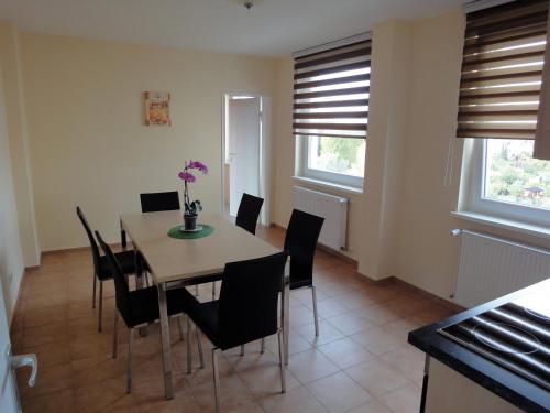 a dining room with a table and chairs at Forsthaus Appartements in Braunschweig