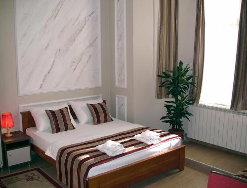 a bedroom with a bed with two towels on it at Apartments Skadarlija in Belgrade