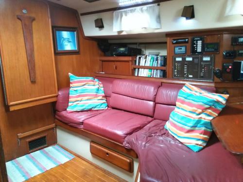 a red leather couch in the back of a boat at Play to Live San Blas in El Porvenir