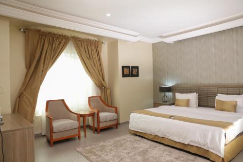 A bed or beds in a room at Heritage Continental Hotel