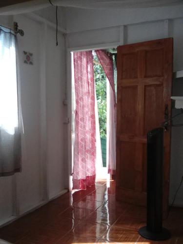 an empty room with a door and a window at Casa MarMaria in Puerto Viejo