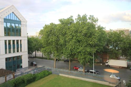 a view of a street with a tree and a building at NEW Design apartment in Brussels in Brussels