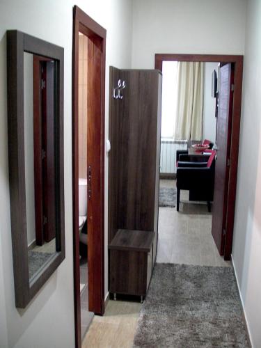 a hallway with two open doors and a mirror at Apartments Skadarlija in Belgrade
