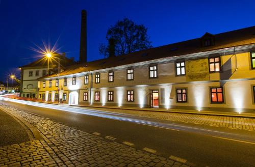 a lit up building on a street at night at Hotel Restaurant Darwin in Prague