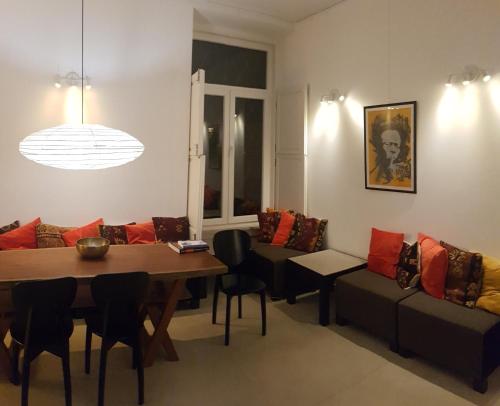 a living room with a table and a couch at Tings Lisbon in Lisbon
