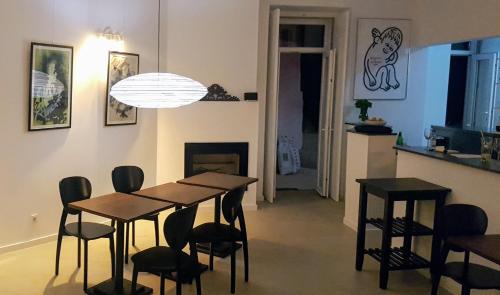 a dining room with a table and chairs and a fireplace at Tings Lisbon in Lisbon