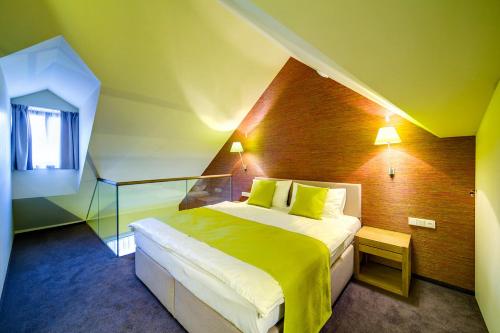 a bedroom with a large bed in a room at Hotel Restaurant Darwin in Prague