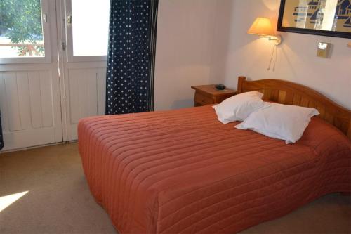 a bedroom with a large orange bed with two pillows at Manantiales Club de Mar in Mar del Plata