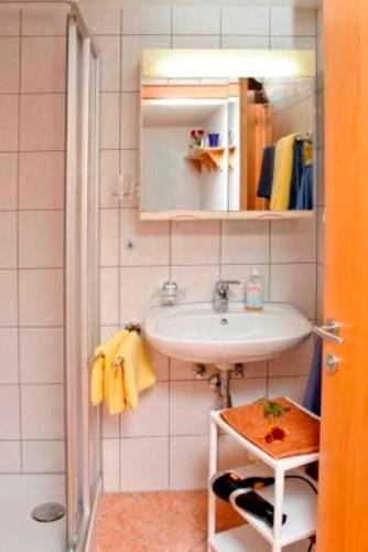 a bathroom with a sink and a mirror at Haus Sonnbühel in Brand