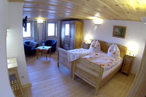 a bedroom with a bed and a living room at Berghof in Zeulenroda