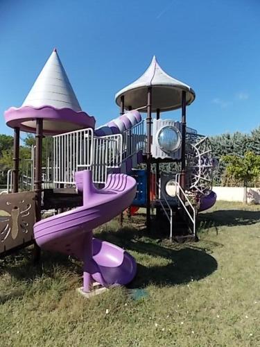 a playground with a purple slide and a gazebo at Domaine De La Bégude in Fayence